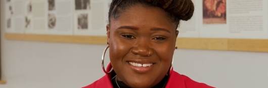 Closeup of Iyana Jolicouer in red collared shirt at UL Solutions. 